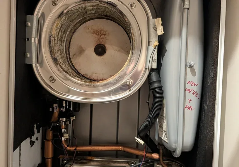 Boiler opened up during a repair, with a newly fitted part marked with the date